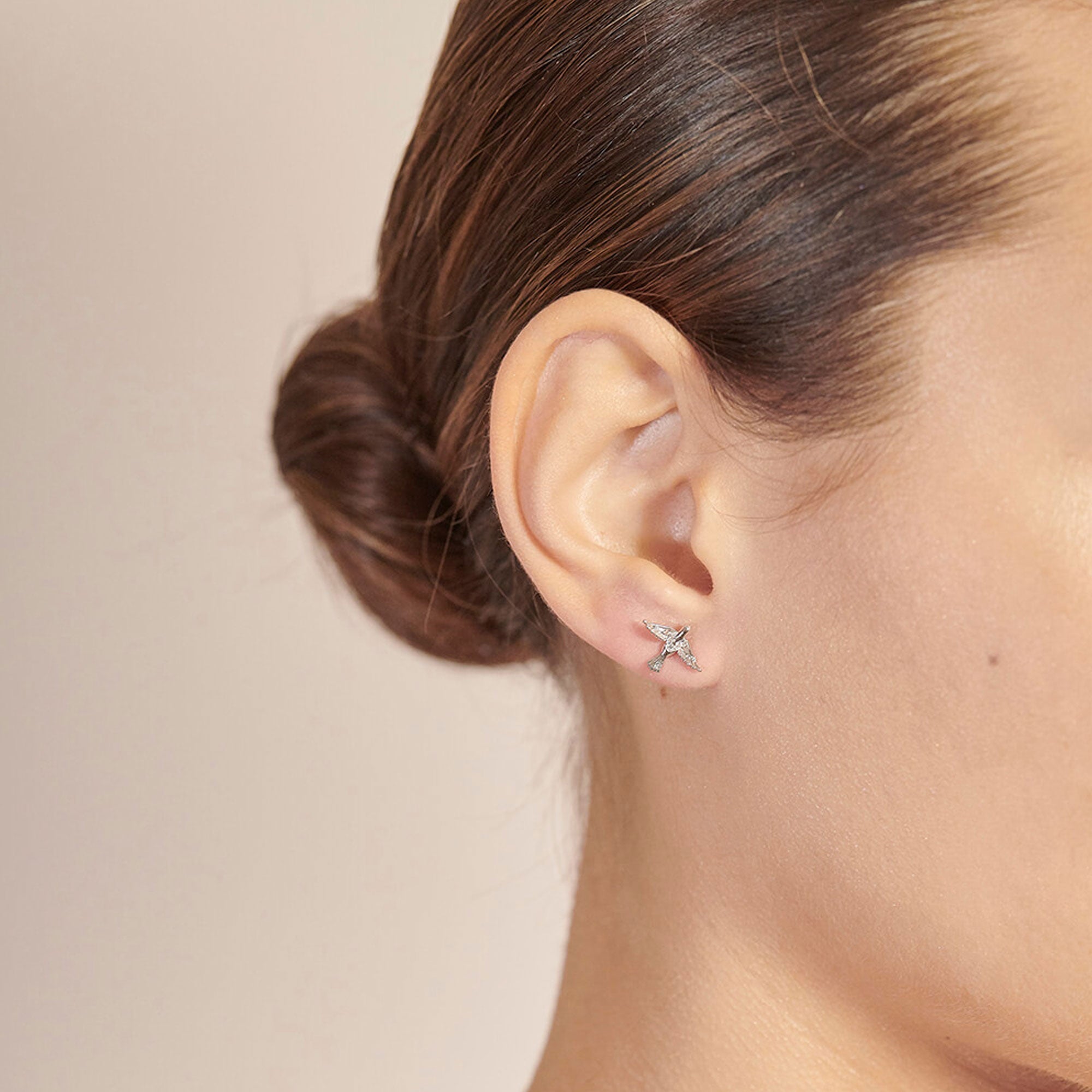 bird earrings in silver on model